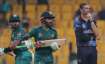 Pakistan's captain Babar Azam and Mohammad Rizwan run between wickets as Namibia's David Wiese watch