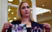 Mavys Alvarez shows photographs of her with Diego Maradona in Havana, Cuba, at the end a press confe