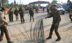Security personnel place the barbed wires outside the
