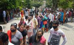Beneficiaries wait in queues to receive COVID-19 vaccine