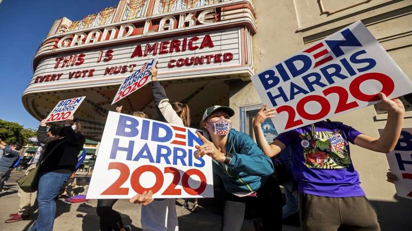 Meredith Walsh celebrates the victory of President-elect Joe Biden and Vice President-elect Kamala Harris in Oakland, California.