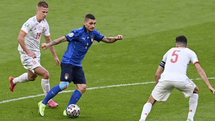 Italy's Marco Verratti runs with the ball at Spain's Sergio Busquets