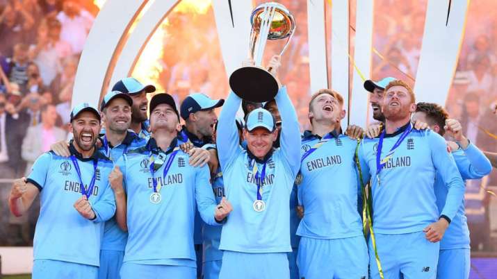 Eoin Morgan of England celebrates with his team as he lifts the Cricket World Cup trophy
